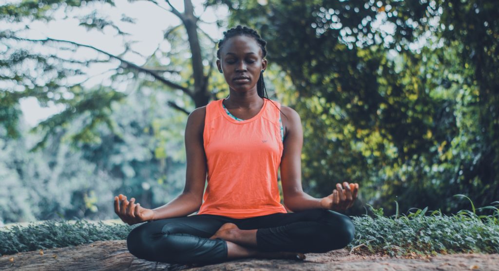 Young woman meditating in nature.