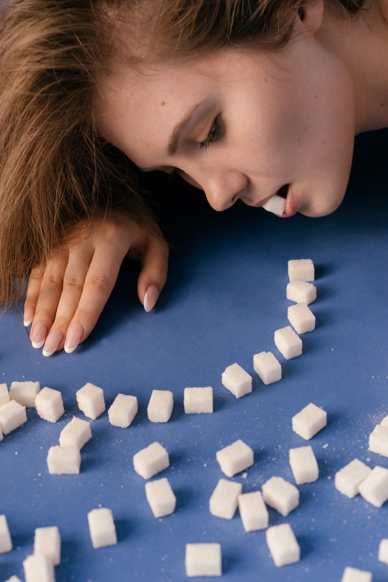 Woman eating sugar cubes